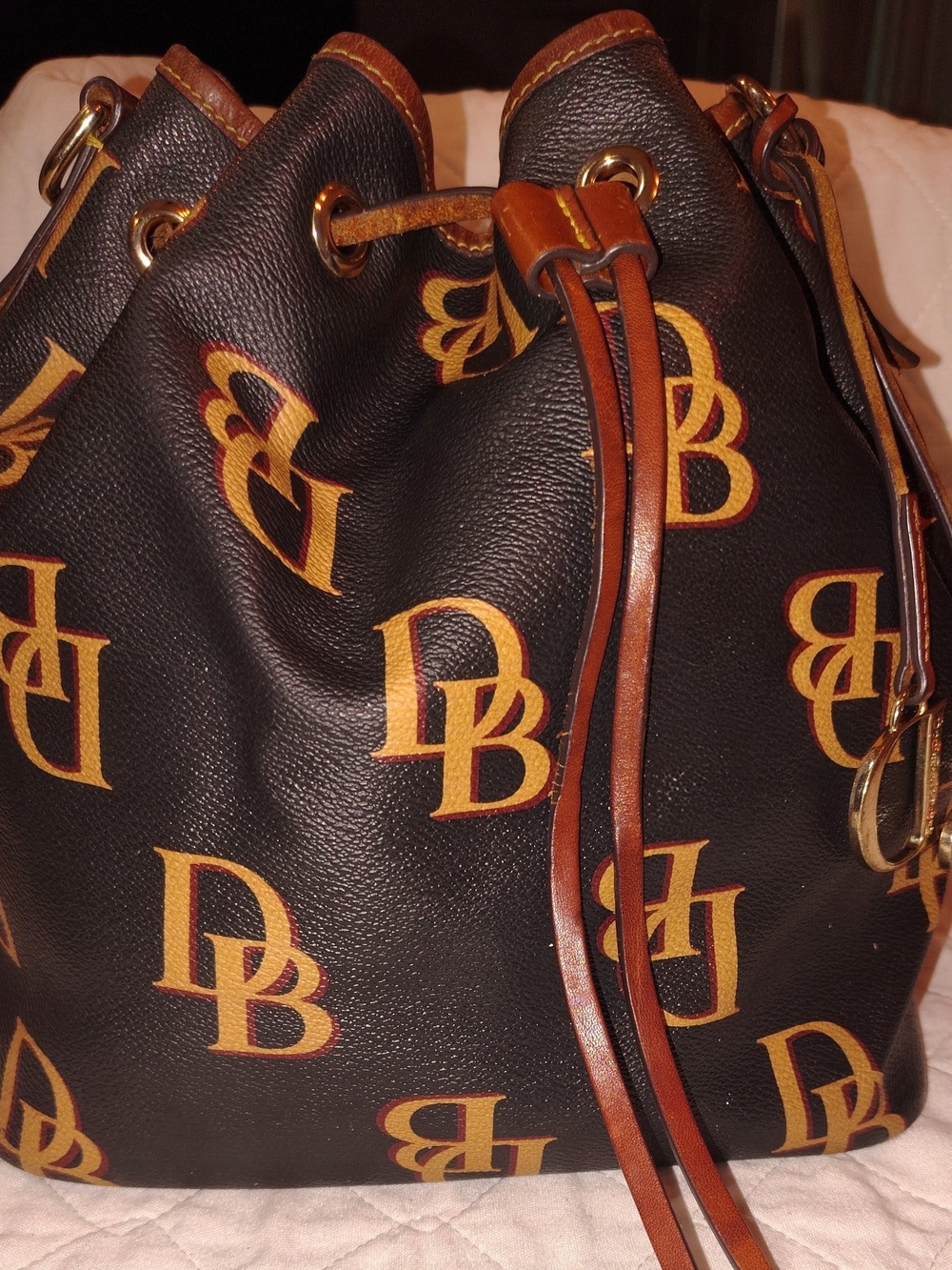 Dooney & Bourke Black and Tan Monogram Drawstring Bucket Bag